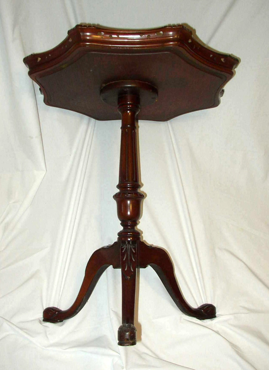 The turned and carved pedestal, legs and feet of the lamp table, like the edge of the top, are  made of gum, colored to look like mahogany.